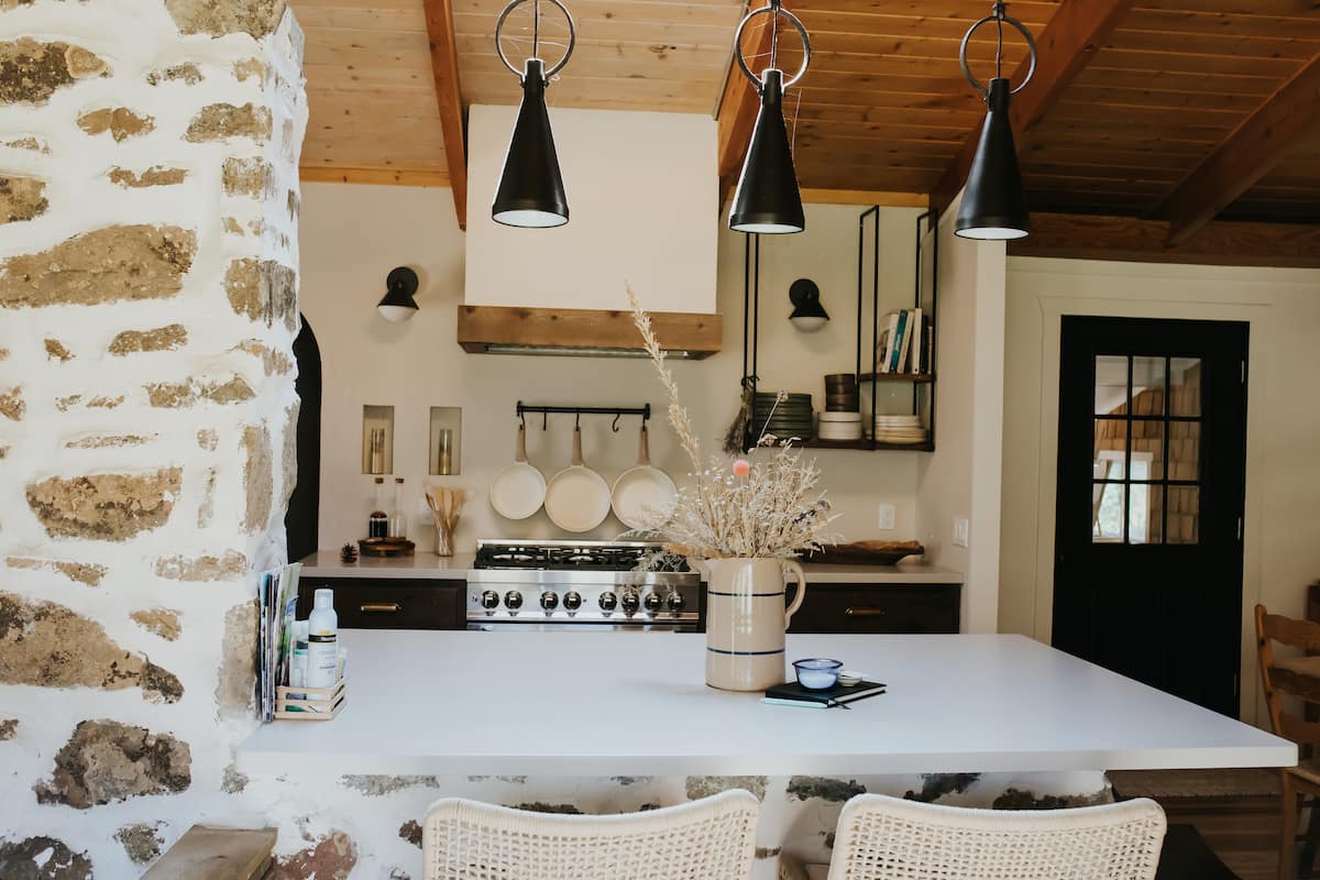 Modern kitchen with cedar beams and river-rock accent wall